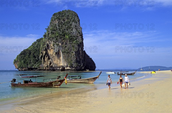 Rocks in the sea, people and longtail boats on Pranang Cave beach, two years in front of the tsunami, Krabi, Thailand, December 2002, vintage, retro, old, historic