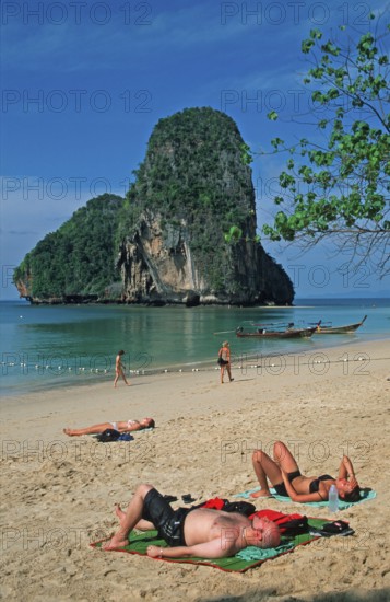 Rocks in the sea, people and longtail boats on Pranang Cave beach, two years in front of the tsunami, Krabi, Thailand, December 2002, vintage, retro, old, historic