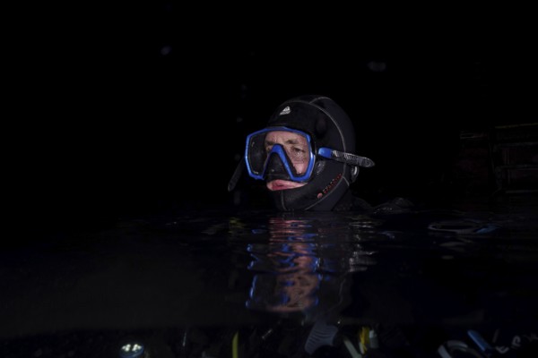 Divers at night in Lake Walen. Tauchplatz Känzeli, Mols, Canton of St. Gallen, Switzerland