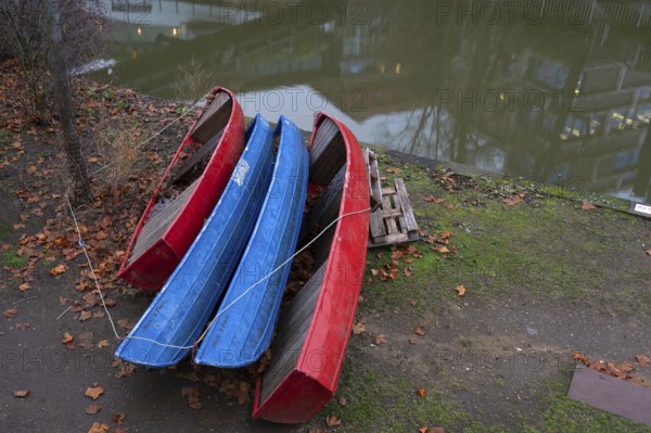 Assembled rowing boats on the banks of Pegnitz, river in Nuremberg, Middle Franconia, Bavaria, Germany