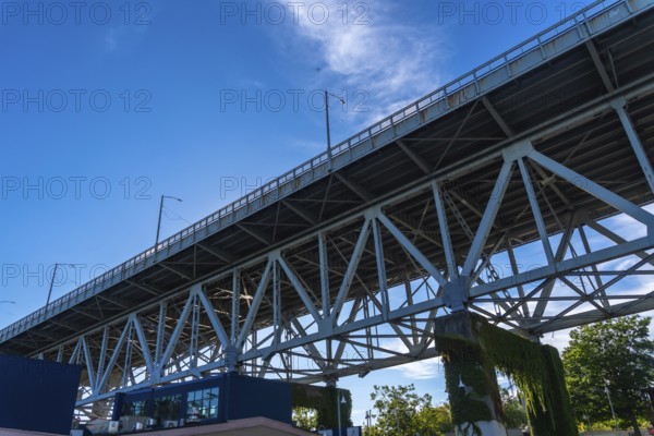 Granville street bridge standing tall against vibrant blue sky, showcasing its impressive steel structure and offering scenic view of vancouver cityscape