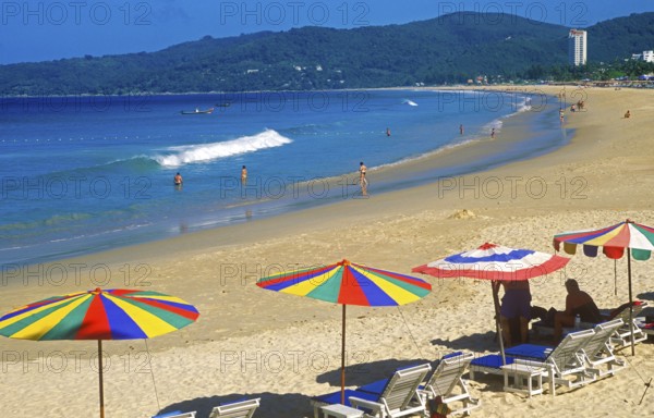 People, umbrellas and sun loungers at Karon Beach, two years in front of the tsunami, Ko Phuket, Thailand, December 2002, vintage, retro, old, historic
