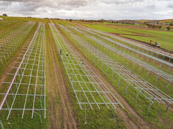 Technical structures of a solar plant under construction on wide fields, energy revolution, construction of PV open space, Baden-Württemberg, Germany