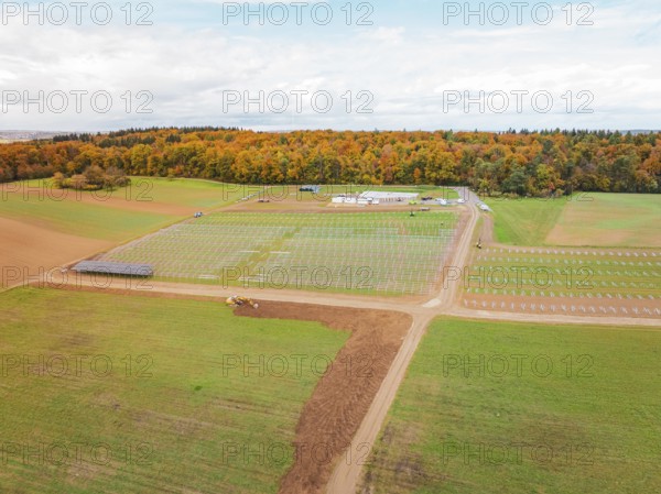 Wide landscape with fields and construction areas for solar systems near forest, energy transition, construction of PV open space, Baden-Württemberg, Germany