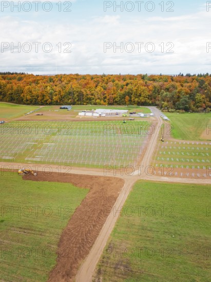 Large-scale construction project for solar energy in fields near a forest, Energiewende, construction of PV open space, Baden-Württemberg, Germany