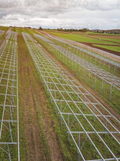 Structures of a solar plant during the construction phase on green fields, energy transition, construction of PV open space, Baden-Württemberg, Germany