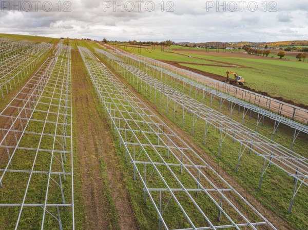 Solar system under construction in fields in a rural landscape, energy transition, construction of PV open space, Baden-Württemberg, Germany