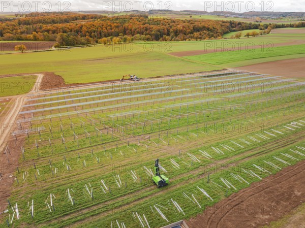 Wide fields with solar panels and green landscape in the background, energy revolution, construction of PV open space, Baden-Württemberg, Germany