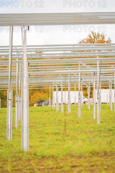 Metal structures for a solar system on a field covered with grass in autumn, energy revolution, construction of PV open space, Baden-Württemberg, Germany