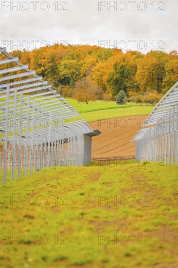 Construction of solar panels between green meadows and fields under autumn skies, energy revolution, construction of PV open space, Baden-Württemberg, Germany