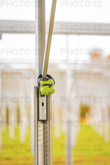 Close-up of a metal structure with headphones attached to a field, Energiewende, construction of PV open space, Baden-Württemberg, Germany