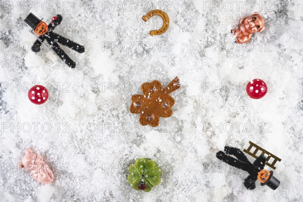 Various lucky charms and decorations on snow, New Year's Eve