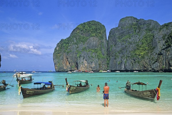 People, longtail boats on Maya Bay beach, known from the movie The Beach, one year in front of the tsunami, Ko Phi Phi Le, Thailand, December 2002, vintage, retro, old, historic