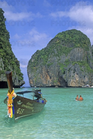 People, longtail boats on Maya Bay beach, known from the movie The Beach, one year in front of the tsunami, Ko Phi Phi Le, Thailand, December 2002, vintage, retro, old, historic