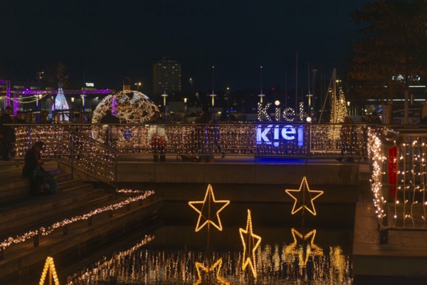 Christmas decoration in Kiel am Holstenfleet, Kleiner Kiel Canal, city center, Christmas, lighting, lights, sailboats, stars, lettering, tree ball, water reflection, evening, darkness, Germany