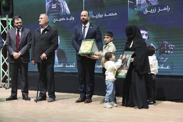 DAMASCUS, SYRIA - DECEMBER 6, 2025: Ministers and high-ranking officials of the newly formed Syrian government attend a symbolic ceremony to honor the families of victims who lost their lives during the Syrian war. The event, held in the capital Damascus, aims to provide social and symbolic recognition to the relatives of those fallen during the conflict as part of the country's transitional or commemorative phase, Damascus, Damascus, Syria