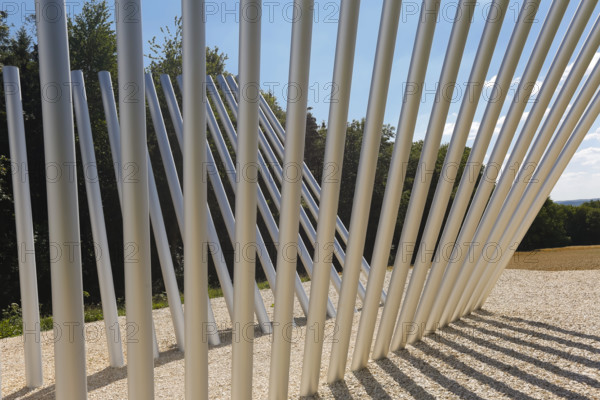 Art in public space, sculpture made of aluminum profile pipes by artist Martin Burchard, life's horizon path near Mundingen, light and shadow, gravel, clouds, blue sky, walk-in art, paths of reflection and refreshment on the Ehinger Alb, Baden-Württemberg, Germany