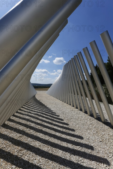 Art in public space, sculpture made of aluminum profile pipes by artist Martin Burchard, life's horizon path near Mundingen, light and shadow, gravel, clouds, blue sky, walk-in art, paths of reflection and refreshment on the Ehinger Alb, Baden-Württemberg, Germany