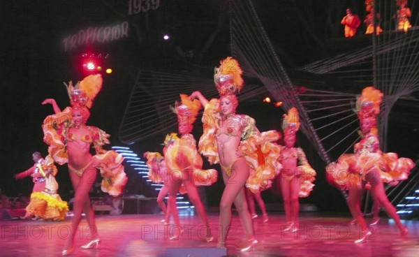 Revue dancers in opulent colorful costume and with feather headdress at Club Tropicana, Havana, Havana, Cuba