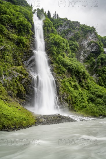 Horsetail Falls waterfall on the Lowe River in a green gorge, long exposure, Keystone Canyon, Richardson Highway, Alaska, USA