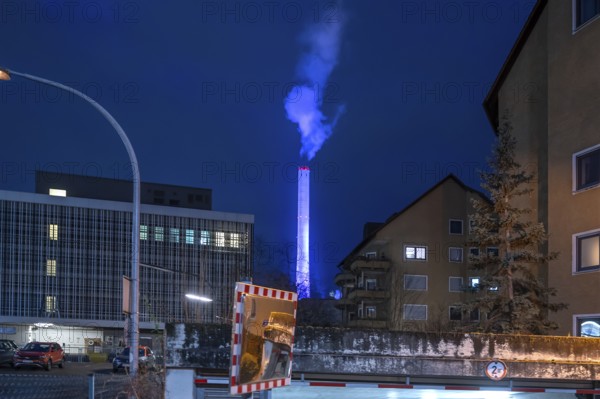 Glowing blue chimney from the CHP plant in the evening, Erlangen.Mittelfranken, Bavaria, Germany