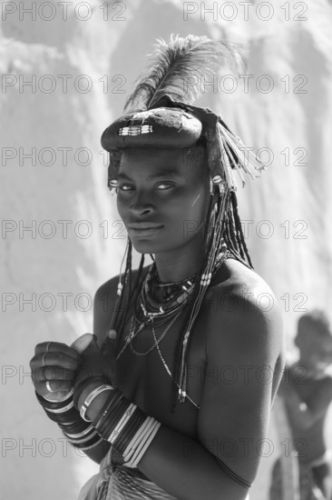 Black and white, portrait, brightly decorated woman of the Hakaona tribe, also Havakona or Hakawona, near Opuwo, Kunene, Namibia
