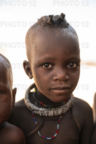 Portrait, curious Himba child, traditional Himba village, Kaokoveld, Kunene, Namibia