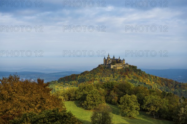 Castle and autumnal forest, Hohenzollern Castle, sunrise, Hechingen, Swabian Jura, Baden-Württemberg, Germany