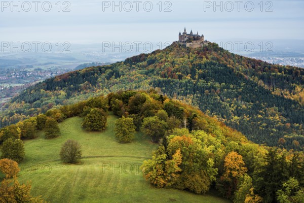 Castle and autumnal forest, Hohenzollern Castle, Hechingen, Swabian Jura, Baden-Württemberg, Germany