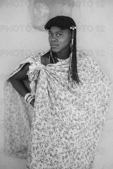 Black and white, portrait, brightly decorated woman of the Hakaona tribe, also Havakona or Hakawona, near Opuwo, Kunene, Namibia