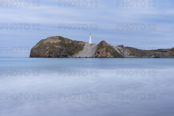 Castlepoint Beach with lighthouse on the rock, ocean, long exposure. Castlepoint, Wairarapa Coast, Wellington Region, North Island, New Zealand