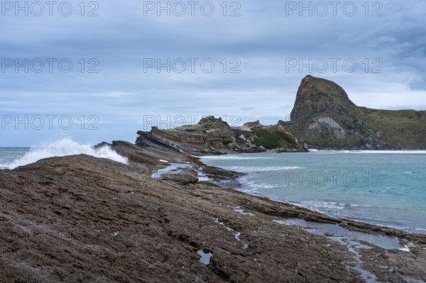 Deliverance Cove and Castle Rock, rocks, ocean, surf. Castlepoint, Wairarapa Coast, Wellington Region, North Island, New Zealand