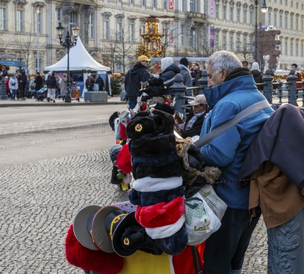 Street vendor wearing Russian army and fur caps, Karl-Liebknecht-Straße, Berlin, Germany