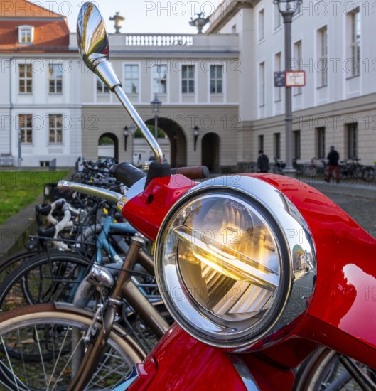 Detailed photo, headlights on a red Vespa, Berlin, Germany