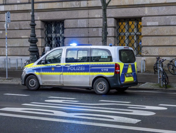 Police vehicles with flashing lights switched on, special operation at the Berlin State Library, Unter den Linden, Berlin, Germany
