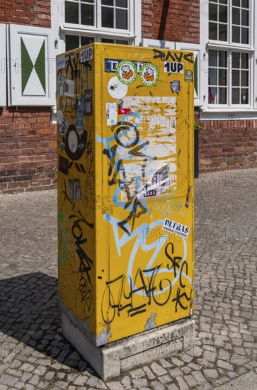 Deutsche Post letterbox with stickers and graffiti, Potsdam, Brandenburg, Germany