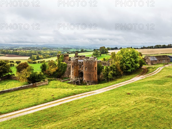Autumn Colours over ruins of Pembridge Castle or Newland Castle from a drone, Herefordshire, England, United Kingdom