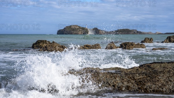 Castlepoint Beach and Castlepoint Lighthouse, ocean, waves, surf, sandy beach, rocks. Castlepoint, Wairarapa Coast, Wellington Region, North Island, New Zealand