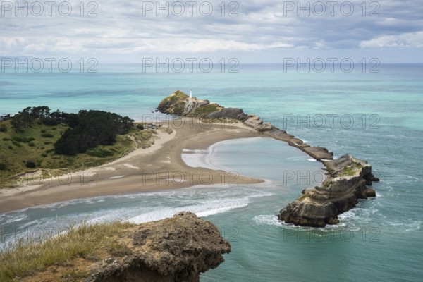Deliverance Cove and Castlepoint Lighthouse, Castle Rock views, rocks, ocean. Castlepoint, Wairarapa Coast, Wellington Region, North Island, New Zealand