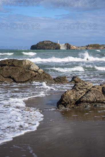 Castlepoint Beach and Castlepoint Lighthouse, ocean, waves, surf, sandy beach, rocks. Castlepoint, Wairarapa Coast, Wellington Region, North Island, New Zealand