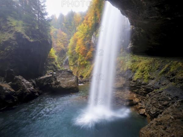 Waterfall mountain list in autumn-colored surroundings, Linthal, Klausenpass, Canton of Glarus, Switzerland