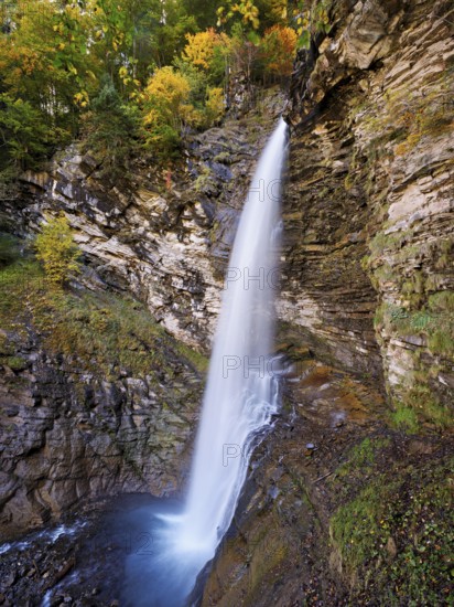 Diesbach waterfall in autumn-colored surroundings, Linthal, Klausenpass, Canton of Glarus, Switzerland