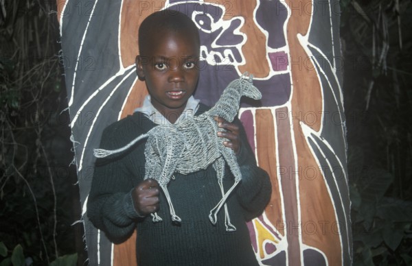 Child with homemade artwork in a self-help project in Chitungwiza near Harare, Zimbabwe, Africa, June 2000, vintage, retro, old, historical