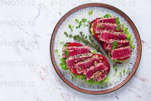 Sandwiches with fried tuna fillet in sesame seeds, breakfast, top view, homemade
