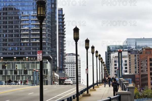 Street lights on Congress Street Bridge, passers-by on pedestrian walkway, office towers, Financial District, Downtown, Boston, Massachusetts, New England, USA