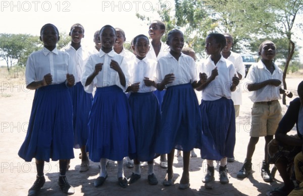 Children from a World Vision project dance on the occasion of a godfather's visit, Nyabubinza, Tanzania, Africa, June 2000, vintage, retro, old, historical