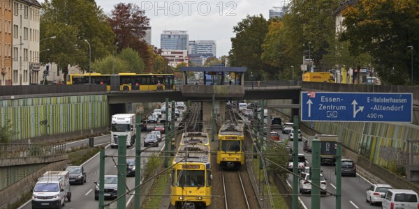 Lots of traffic on the A 40 motorway on four lanes and two subways on two lanes and a bus on the bridge, infrastructure, Essen, Ruhr area, North Rhine-Westphalia, Germany