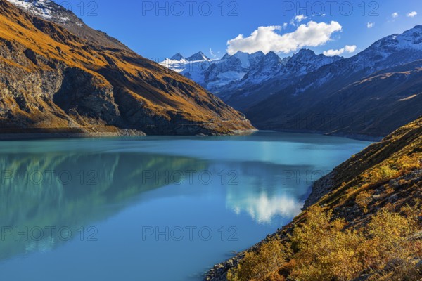 The Lac de Moiry reservoir, with the snow-capped peaks of the Grand Cornier, Tete Blanche and Pointe Moiry mountains, Val d'Anniviers, Valais Alps, Canton of Valais, Switzerland