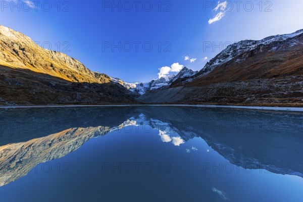 The Moiry glacier and mountain peaks are reflected in Lac de Chateaupre, Val d'Anniviers, Valais Alps, Canton of Valais, Switzerland