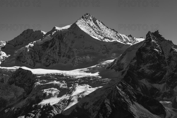 The snow-capped peaks of the Zinalrothorn and Besso mountains, black and white photo, Val d'Anniviers, Valais Alps, Switzerland
